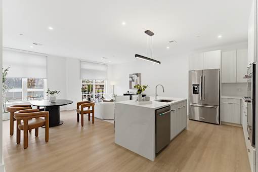 A modern kitchen with a dining table and chairs.