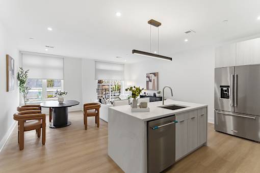 A modern kitchen with a large island and stainless steel appliances.