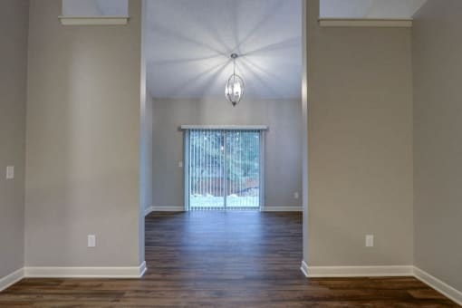 an empty living room with a sliding glass door