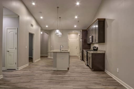 a kitchen and living room with a hardwood floor