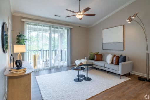 a living room with a couch and a ceiling fan
