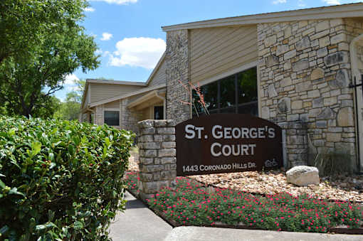 A sign that says St. George's Court in front of a building.