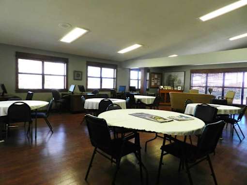 A room with tables and chairs is set up for an event.
