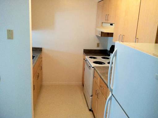 A kitchen with a white refrigerator, a white dishwasher, and a white stove.