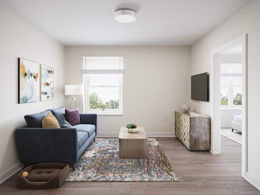A living room with a blue couch and a rug. at Divinity Landing Apartments, Ohio, 44056
