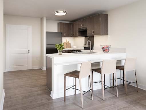 A kitchen with a white island and brown chairs. at Divinity Landing Apartments, Ohio