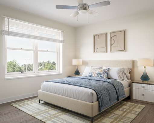 A bedroom with a large bed and a ceiling fan. at Divinity Landing Apartments, Macedonia, OH, 44056