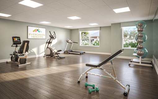 A gym with a variety of equipment including a treadmill, weights, and a bench press. at Evergreen Heights Apartments, Toledo, OH, 43614