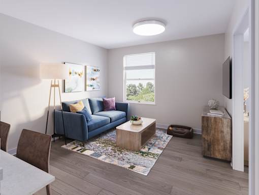 A living room with a blue couch, a wooden coffee table, and a television. at Evergreen Heights Apartments, Ohio, 43614