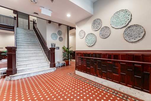 A staircase with a red and white checkered floor.