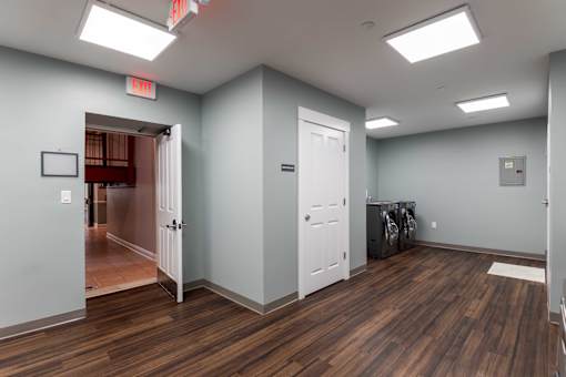 A room with wood flooring and white doors.