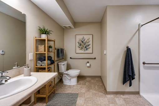 A bathroom with a white toilet, sink, and a white shower.