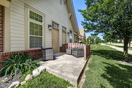 A house with a brown door and a brown fence.