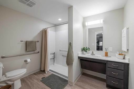 A bathroom with a toilet, sink, and shower.