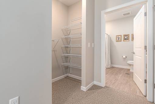 A white door is open to a bathroom.