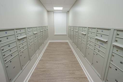 A long hallway with a series of mailboxes on the wall.