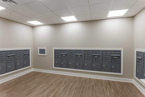 A room with a row of mailboxes on the wall.