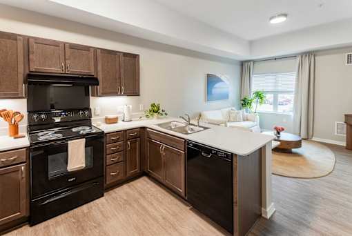 A modern kitchen with dark wood cabinets and appliances.