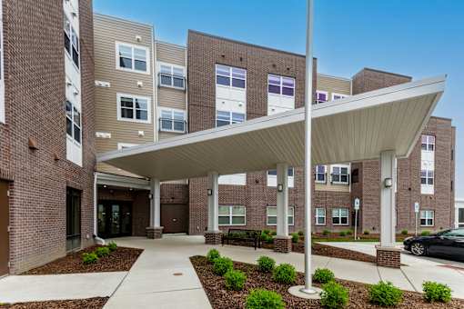 A modern building with a covered walkway and brick exterior.