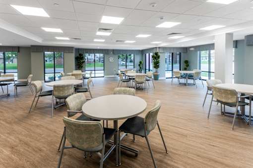 A conference room with a table surrounded by chairs.