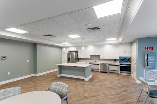 A kitchen area with a dining table and chairs.