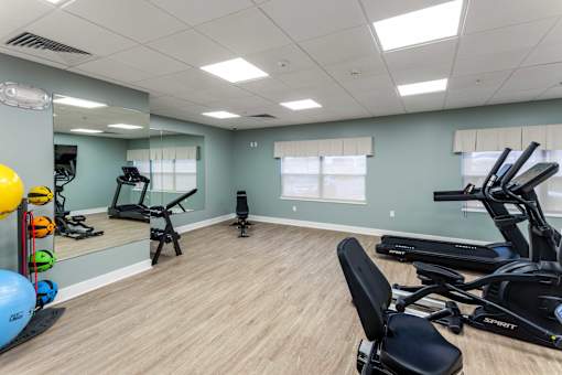 A spacious gym with a variety of exercise equipment.