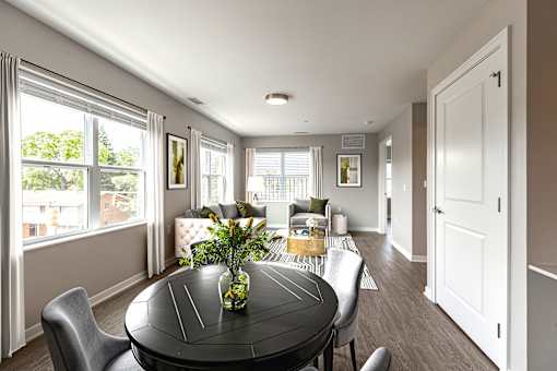 A dining room with a table and chairs.