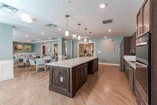 A kitchen with a wooden island and stainless steel appliances.