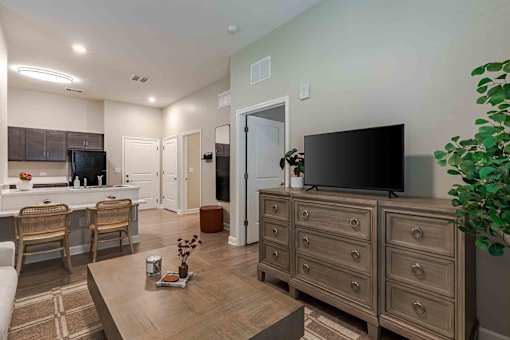 A living room with a television on a wooden cabinet.