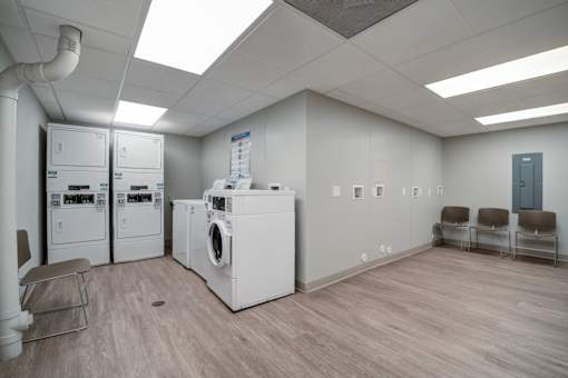 A laundry room with washers and dryers.
