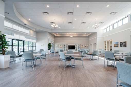 A large room with a long table and chairs.