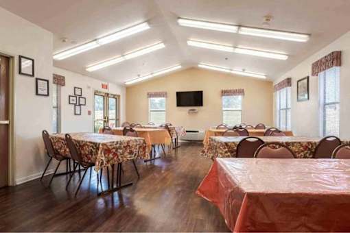 A room with tables and chairs set up for an event.
