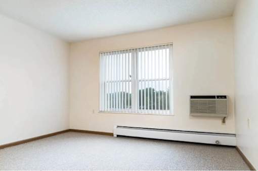 A room with a window and air conditioner.