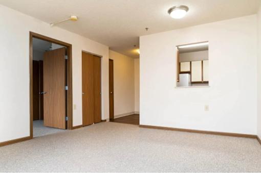 A room with a carpeted floor and a mirror on the wall.