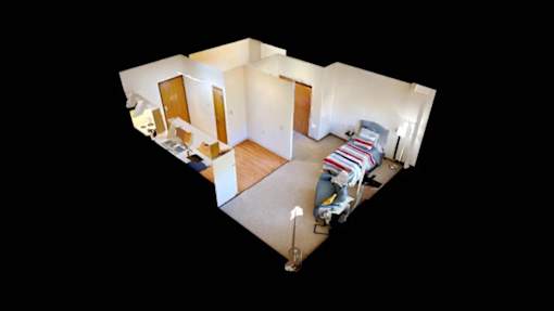 A top down view of a bedroom with a bed and a desk.