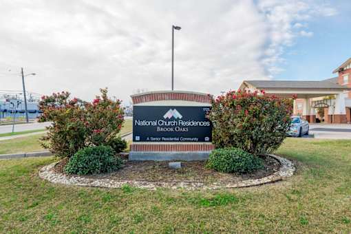 A sign for National Church Residences is in front of a building.