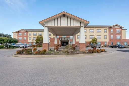 A large building with a covered walkway in front.