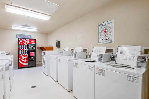 A row of washing machines in a laundromat.