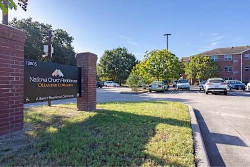 The image shows a sign for National Church Residences Oleander Commons, a senior residential community.
