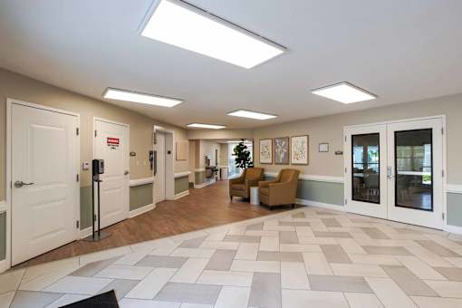 A hallway with a tiled floor and a few doors.