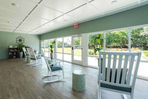 A room with a green wall and a white chair.