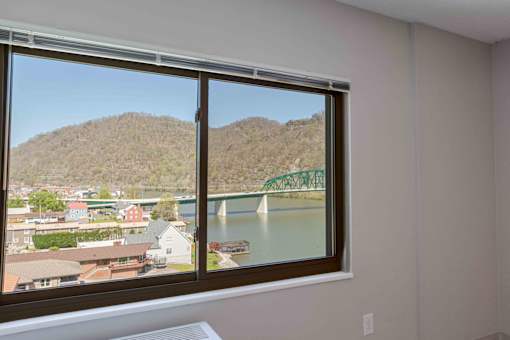 A window with a view of a bridge and a town.