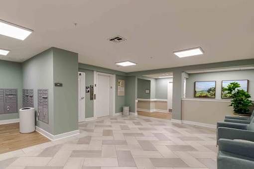 A hallway with a tiled floor and a trash can on the left.