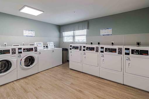 A row of washing machines in a laundromat.