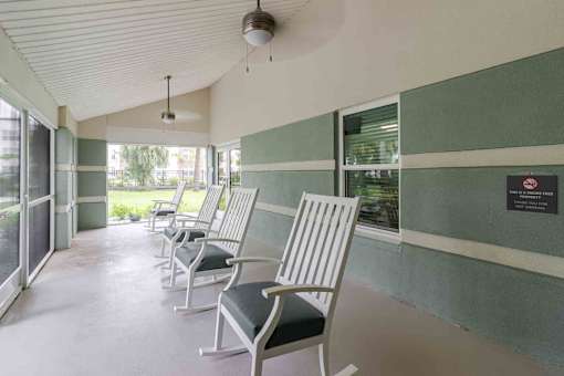 A row of chairs are lined up in a waiting area.