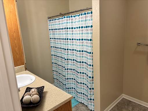 A shower curtain with blue circles on it.