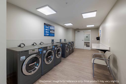 A row of washing machines in a laundromat.