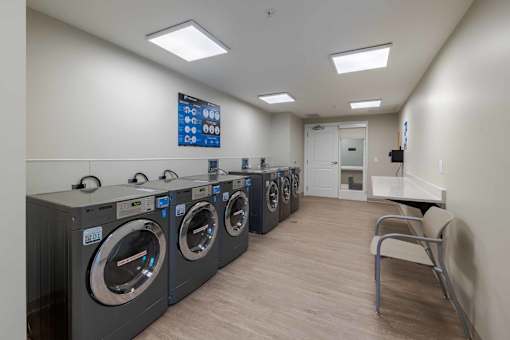 A row of washing machines in a laundromat.