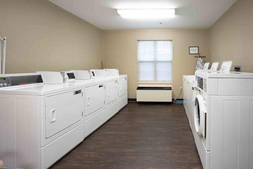 A laundry room with washers and dryers.