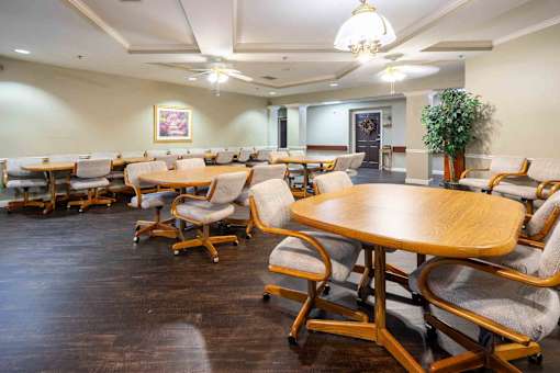 A conference room with wooden tables and chairs.